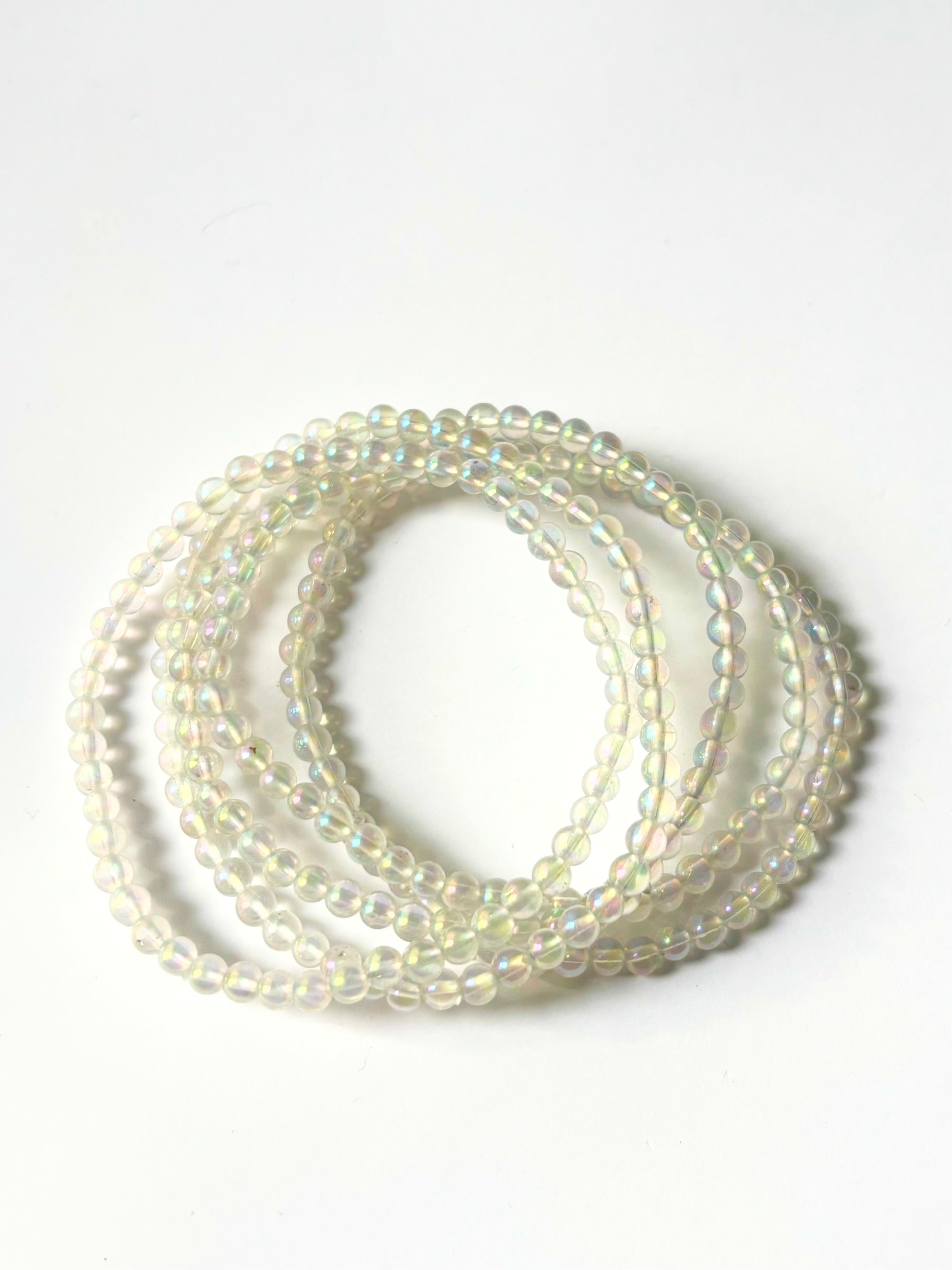 Close-up of crystal healing bracelets showing detailed gemstone rainbow angel aura quartz