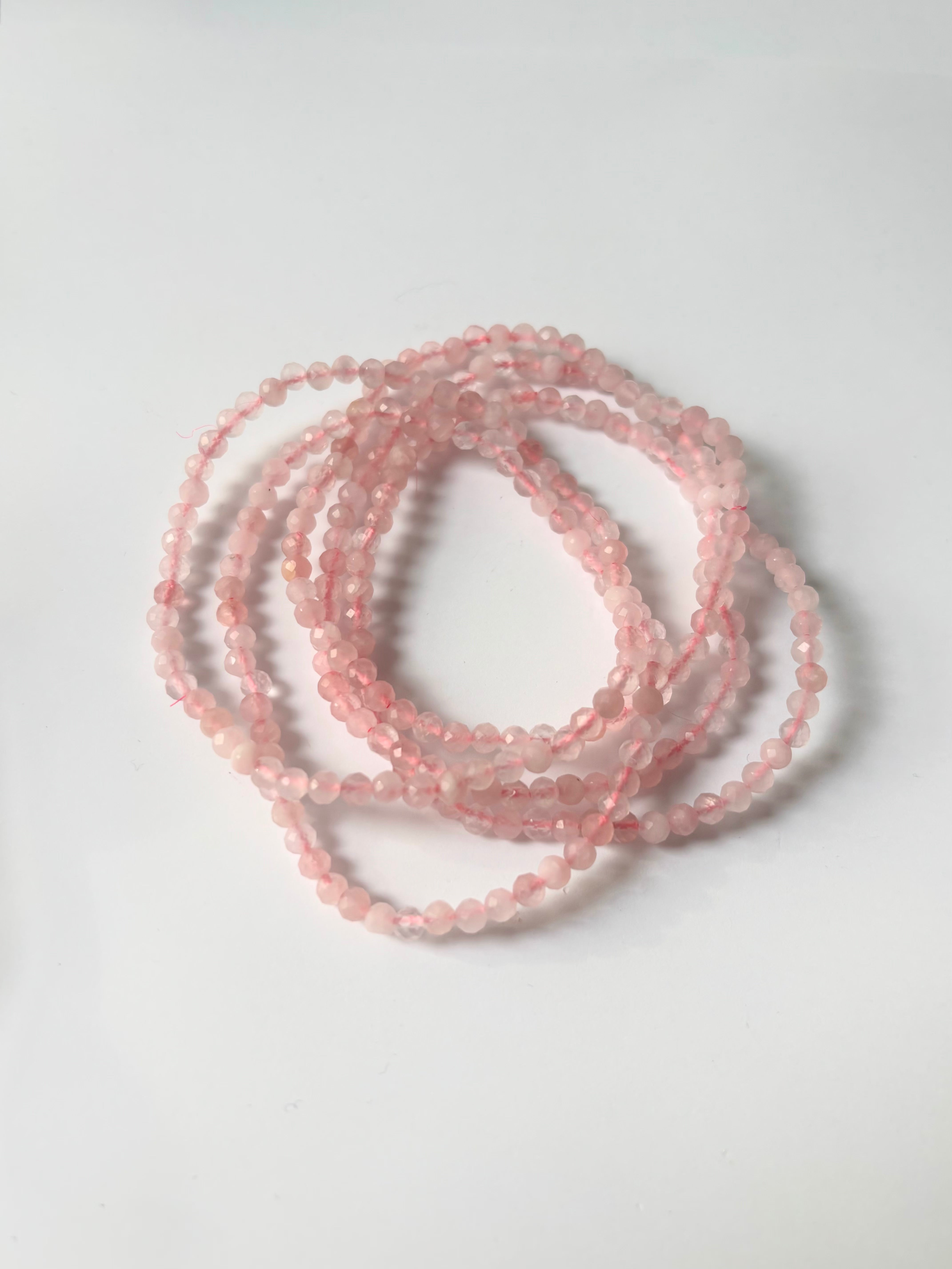 Close-up of crystal healing bracelets showing detailed gemstone rose quartz