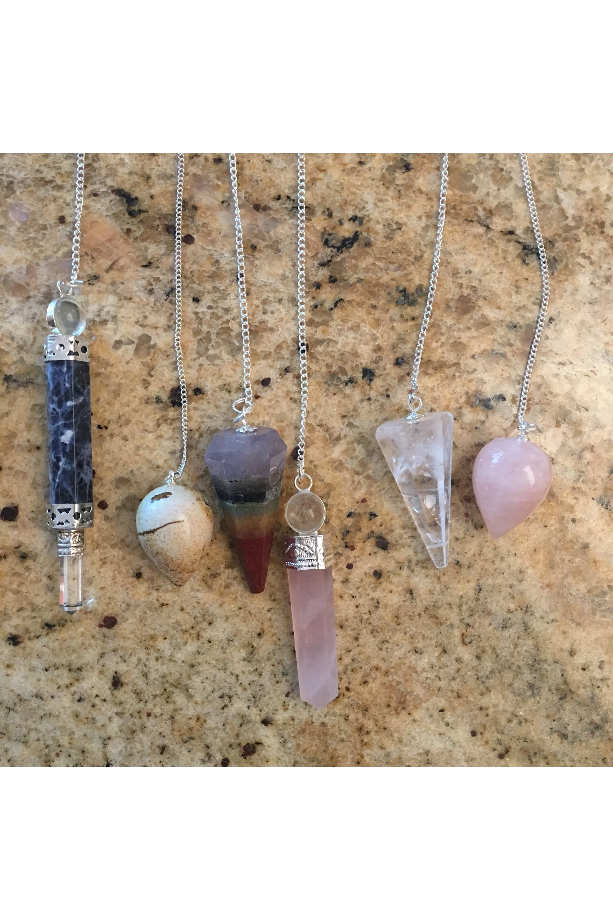 Assorted gemstone pendulums for divination and energy healing