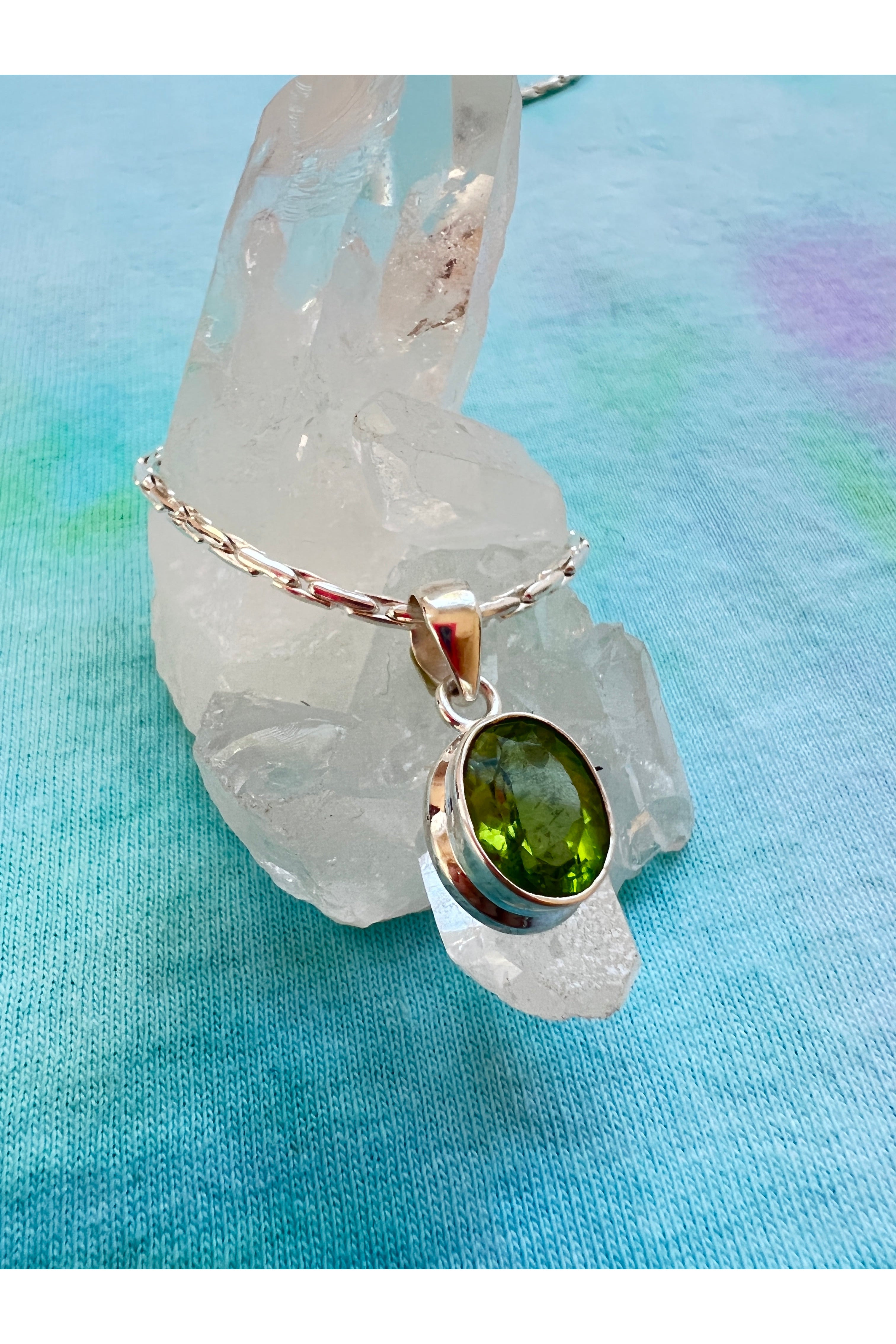 Green peridot crystal necklace promoting heart chakra balance