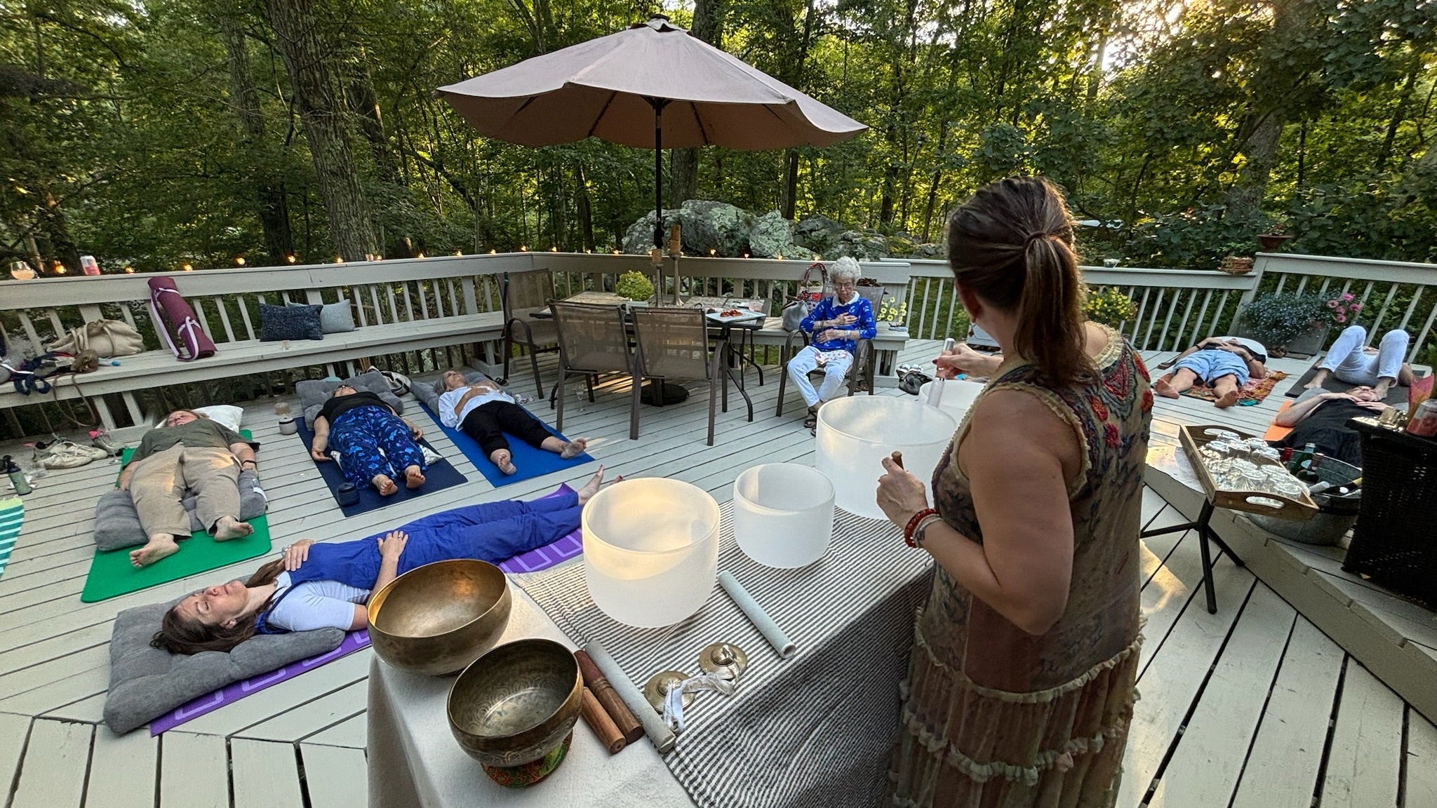 sound bath outside with people laying down meditating