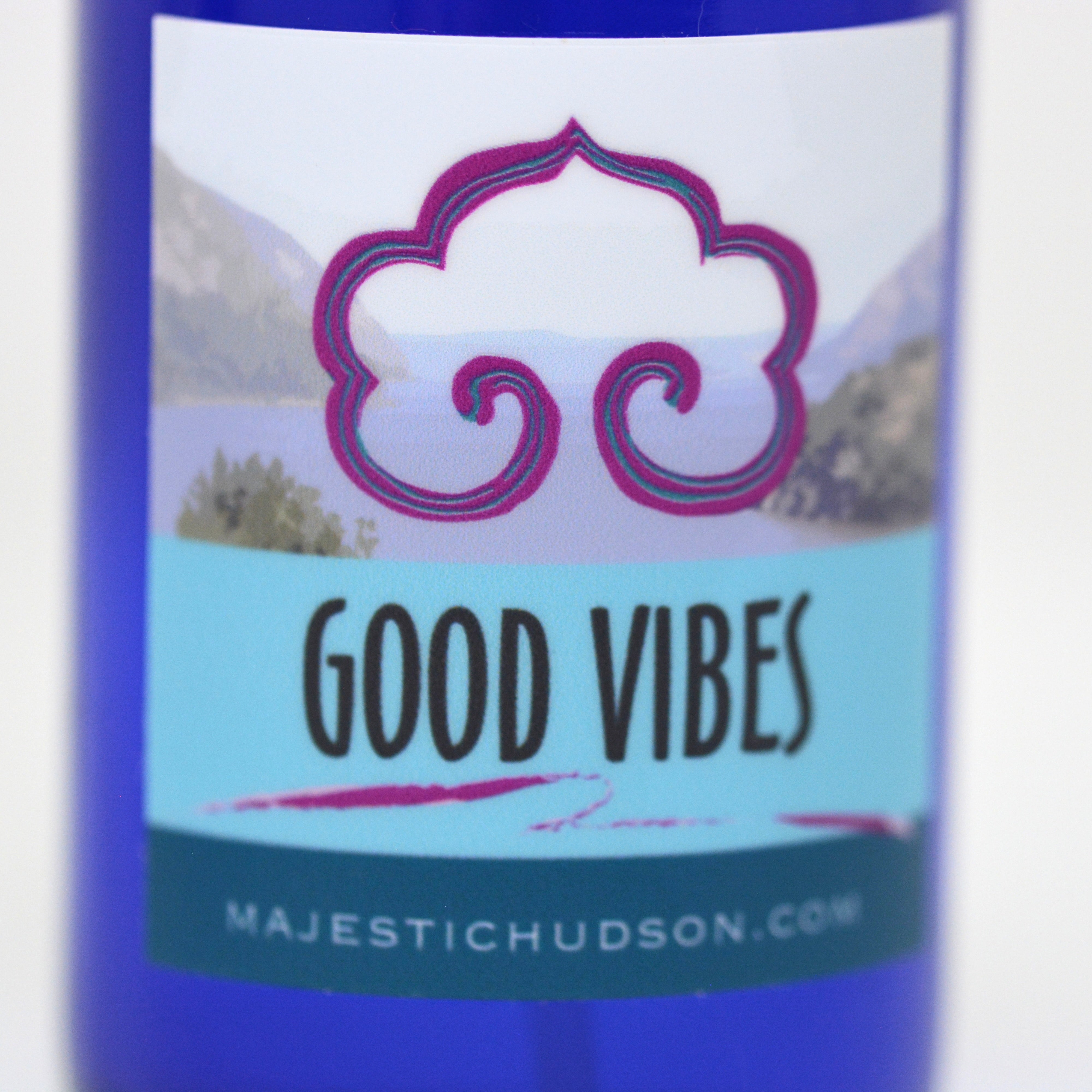 Bottle labeled 'Good Vibes' with a decorative logo on a white background