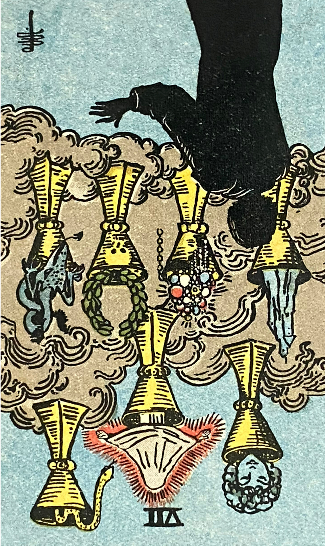 A vintage-style tarot card illustration featuring a black silhouette of a descending hand above gold trumpets, with swirling beige clouds and a light blue background.
