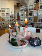 Small handmade candlestick holder styled on an altar with crystals and herbs, creating a beautiful setting for meditation and magic.