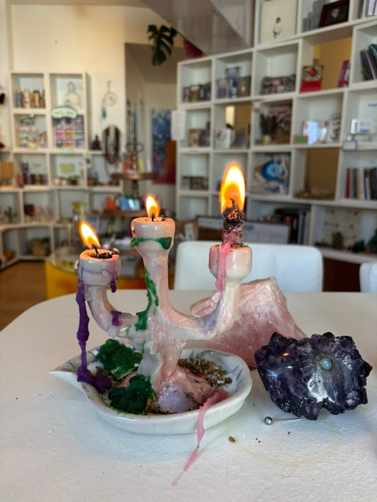 Small handmade candlestick holder styled on an altar with crystals and herbs, creating a beautiful setting for meditation and magic.