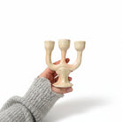 Mini chime candle holder holding a lit ritual candle, ideal for casting spells, manifestation practices, and spiritual ceremonies.