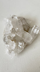 Clear crystal cluster on a light gray background