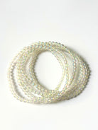 Close-up of crystal healing bracelets showing detailed gemstone rainbow angel aura quartz