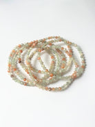 Close-up of crystal healing bracelets showing detailed gemstone sunstone and moonstone