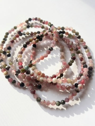 Close-up of crystal healing bracelets showing detailed gemstone watermelon tourmaline 