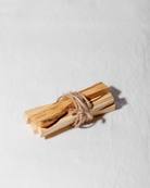 A bundle of Palo Santo sticks used for spiritual cleansing, grounding rituals, and purifying energy with a warm, woodsy scent.