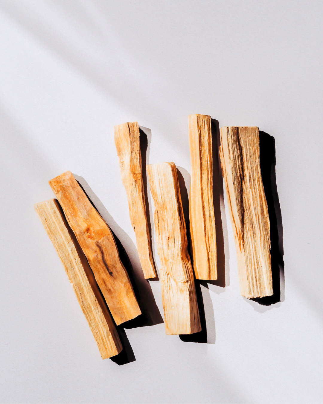 A bundle of Palo Santo sticks used for spiritual cleansing, grounding rituals, and purifying energy with a warm, woodsy scent.