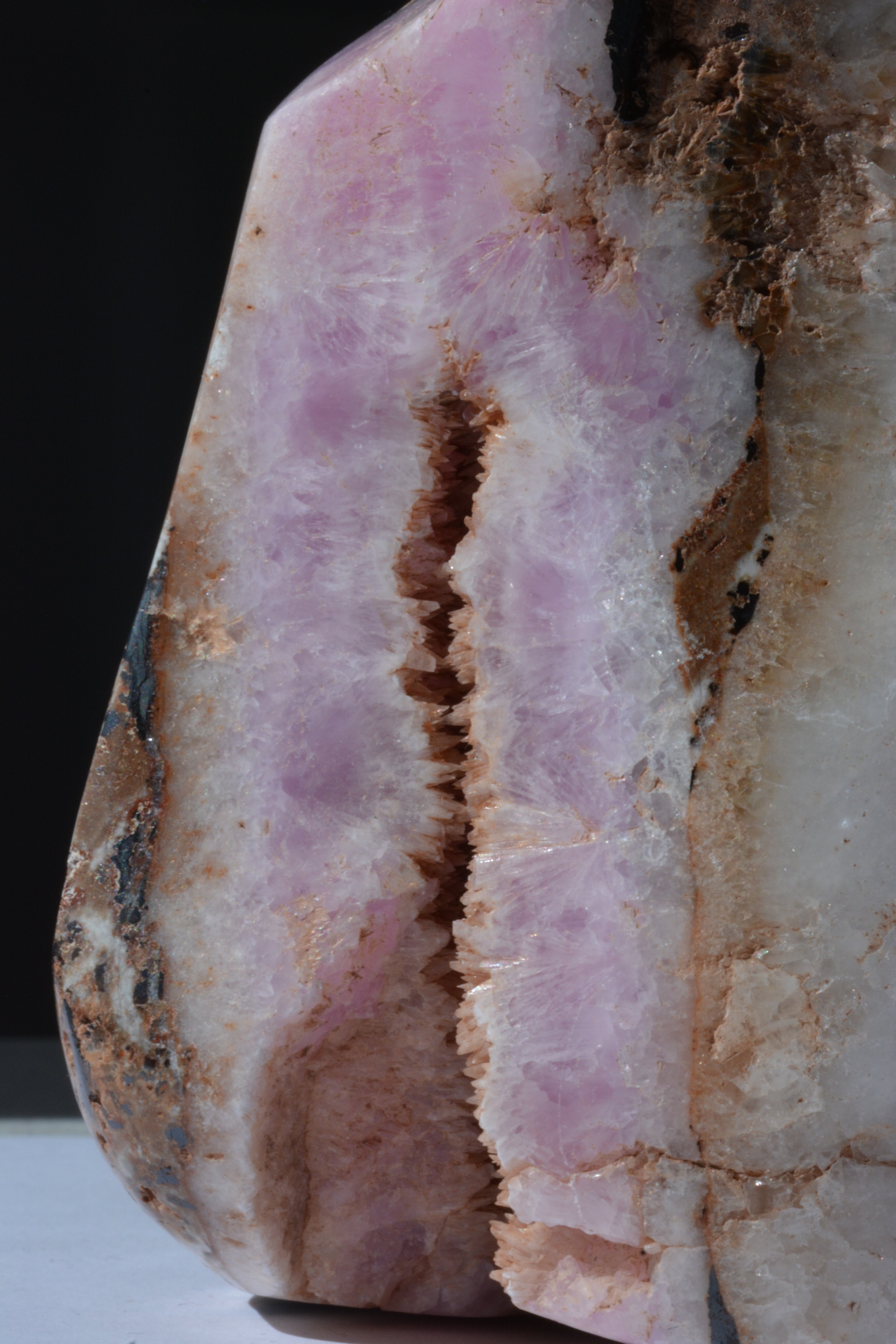 Close-up of pink Aragonite crystal with visible Hematite inclusions – textured raw crystal