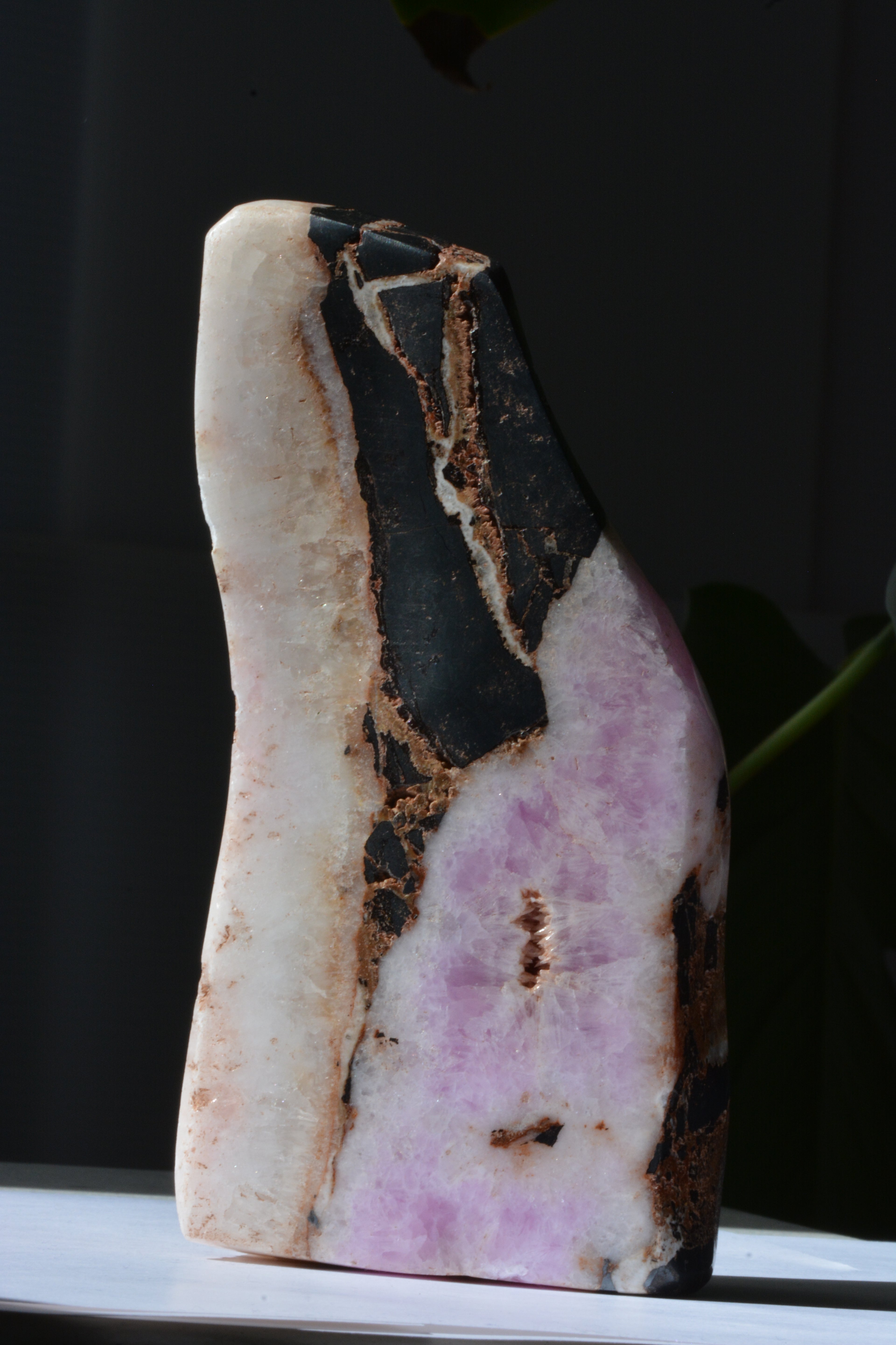 Close-up of pink Aragonite crystal with visible Hematite inclusions – textured raw crystal