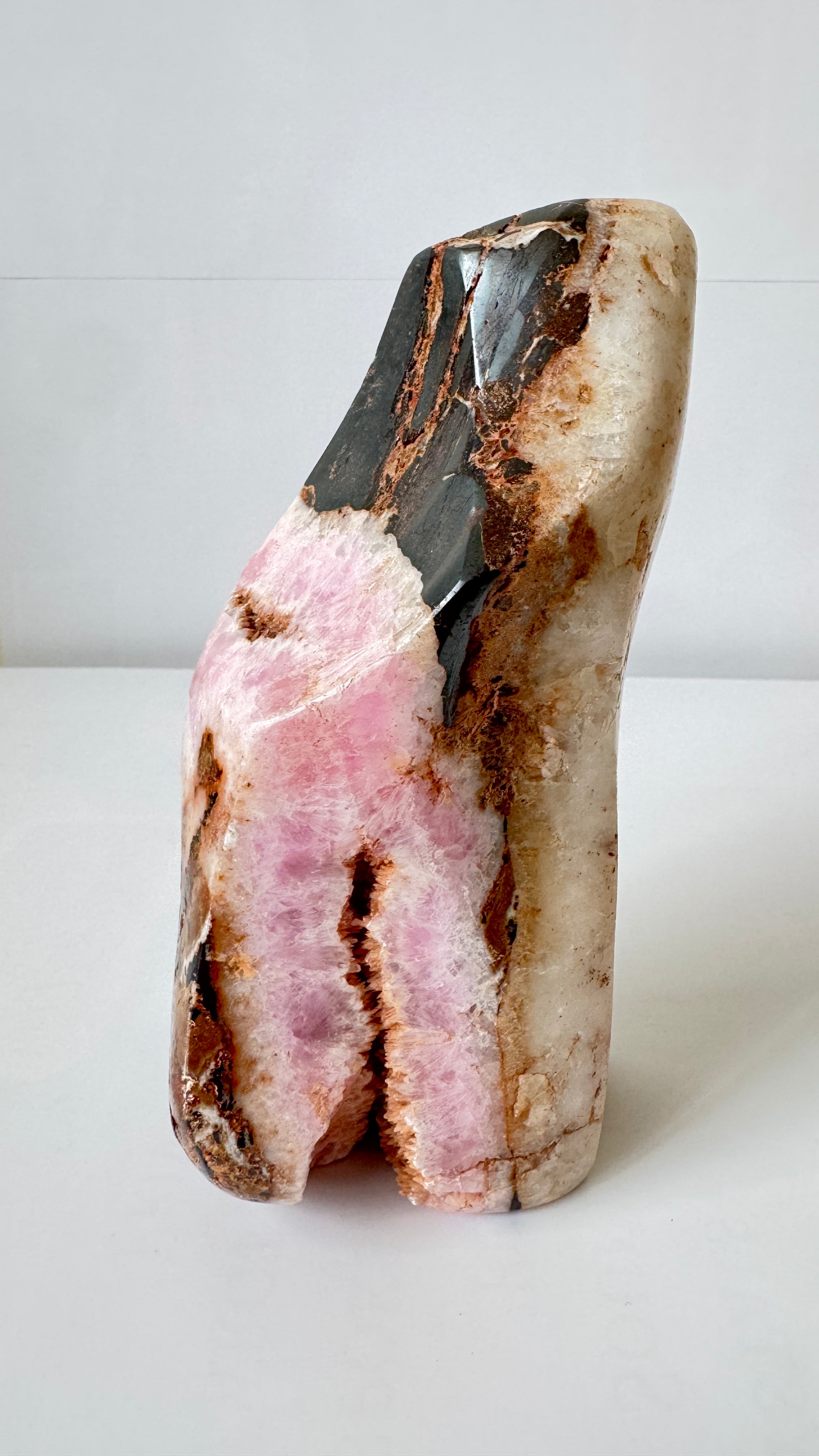 Front view of large pink Aragonite crystal with red Hematite inclusions – raw mineral specimen