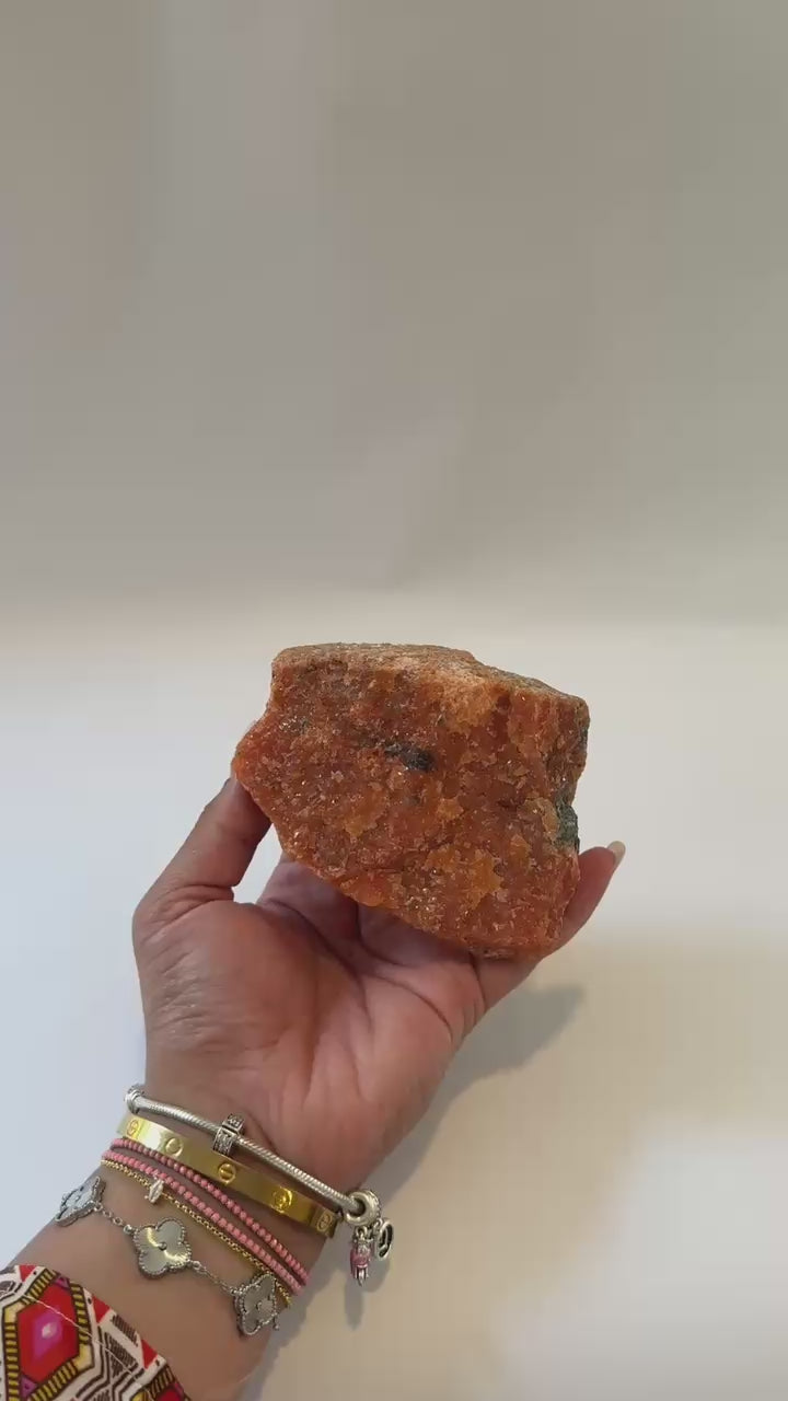 orange calcite specimen with green inclusions