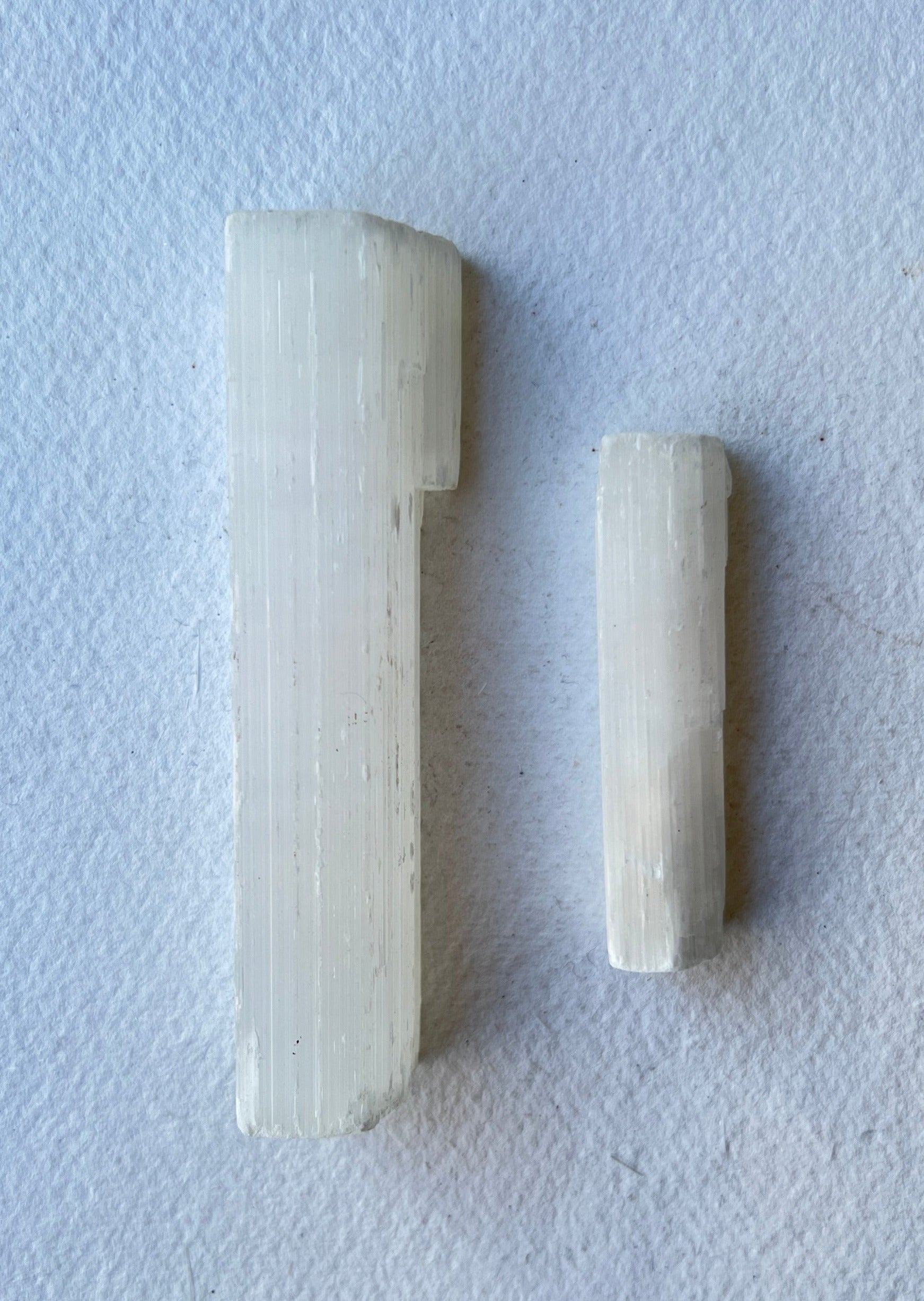 Natural Selenite crystal wand on linen cloth – used for energy cleansing, aura clearing, and spiritual rituals