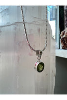 Green peridot crystal necklace promoting heart chakra balance