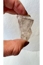 raw smoky quartz crystal with deep grey clarity and natural inclusions